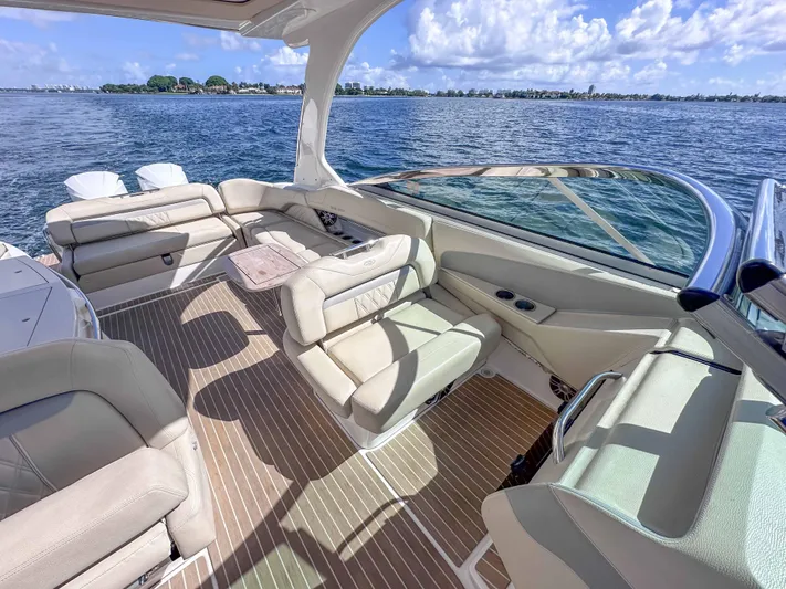 Poly Yacht Photos Pics Luxurious 2019 Regal 33 OBX boat interior with beige seating and scenic ocean view.
