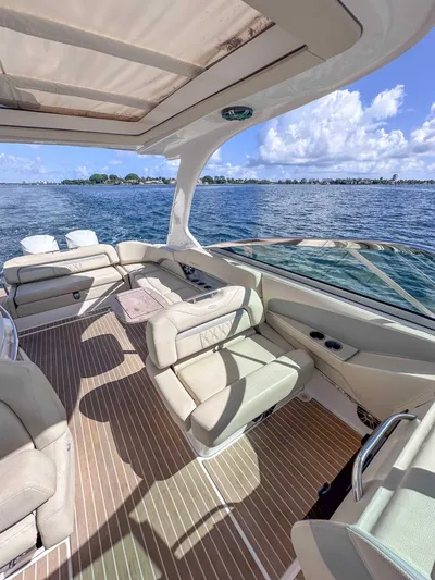 Poly Yacht Photos Pics 2019 Regal 33 OBX boat interior with luxurious seating, open water view, and sunny skies.