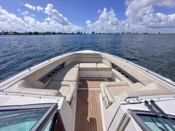 Poly Yacht Photos Pics 2019 Regal 33 OBX boat with spacious seating, cruising on a sunny day.