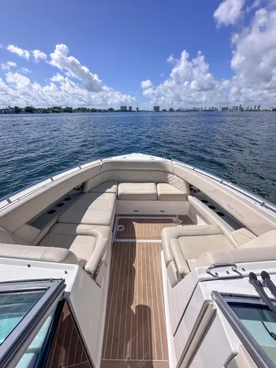 Poly Yacht Photos Pics 2019 Regal 33 OBX boat with spacious seating, cruising on a sunny day.
