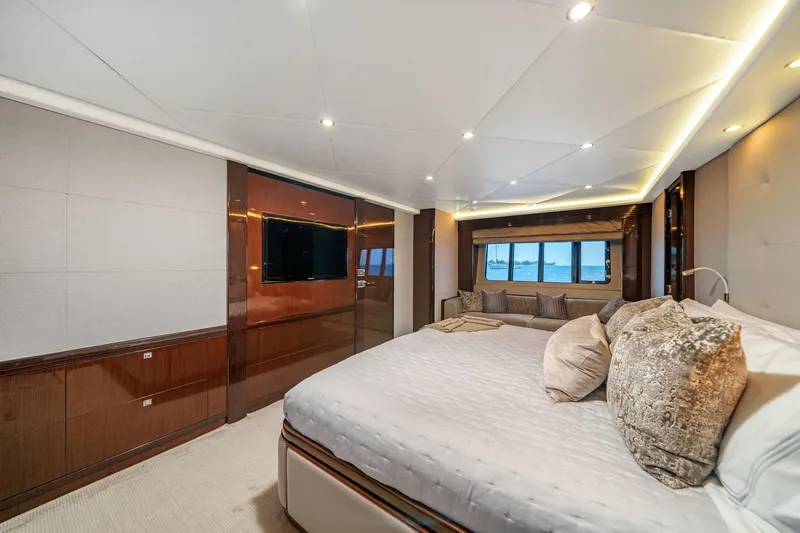 Current Sea Yacht Photos Pics Luxurious bedroom interior of 2011 Princess 95 yacht with elegant decor and sea view.