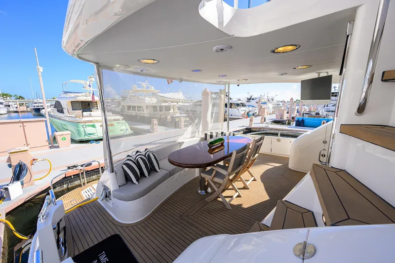 Time Off V Yacht Photos Pics Luxurious 2005 Lazzara 68 Enclosed Bridge yacht with elegant outdoor seating and marina view.