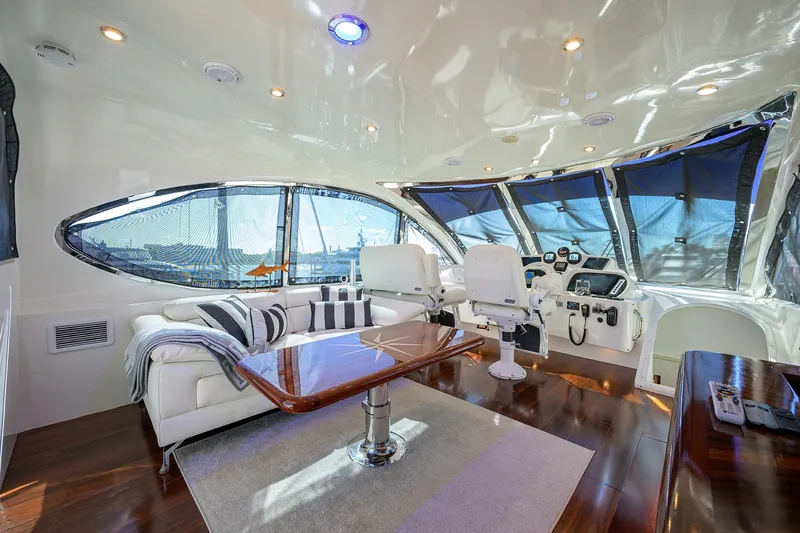 Time Off V Yacht Photos Pics Luxurious interior of 2005 Lazzara 68 Enclosed Bridge yacht with modern helm and seating area.