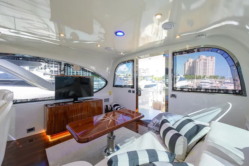 Time Off V Yacht Photos Pics Luxurious interior of 2005 Lazzara 68 Enclosed Bridge yacht with modern furnishings and marina view.