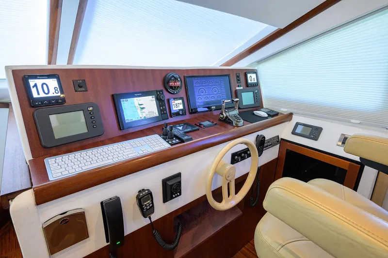 Time Off V Yacht Photos Pics 2005 Lazzara 68 Enclosed Bridge helm with advanced navigation and control systems.