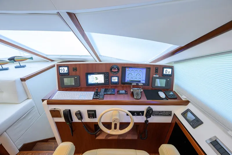 Time Off V Yacht Photos Pics 2005 Lazzara 68 Enclosed Bridge yacht helm with advanced navigation equipment and controls.
