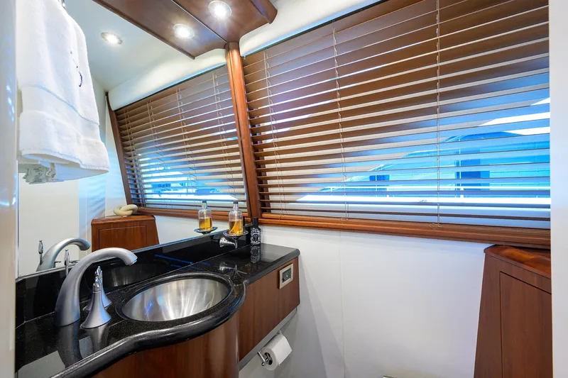 Time Off V Yacht Photos Pics Luxurious bathroom interior of 2005 Lazzara 68 Enclosed Bridge yacht with modern fixtures.