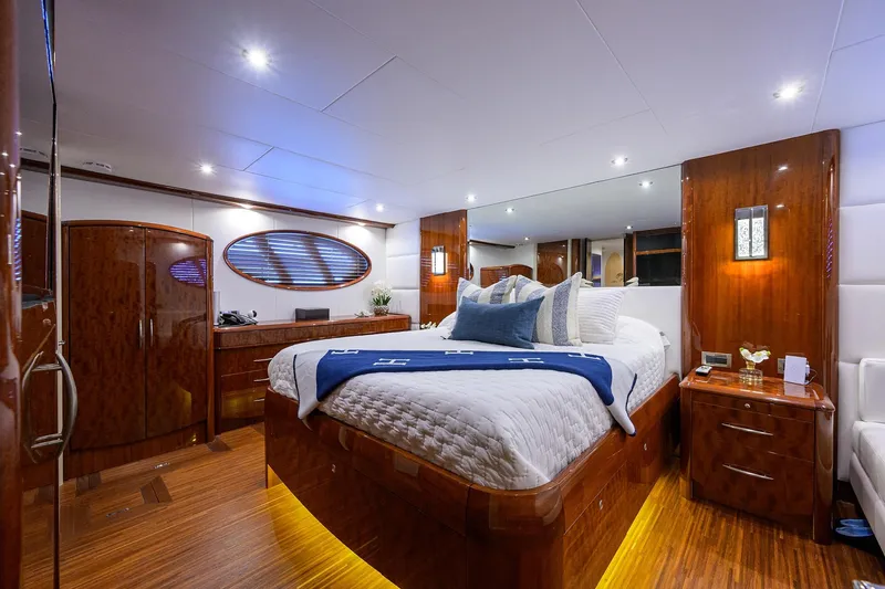 Time Off V Yacht Photos Pics Luxurious bedroom interior of 2005 Lazzara 68 Enclosed Bridge yacht with elegant wood finishes.