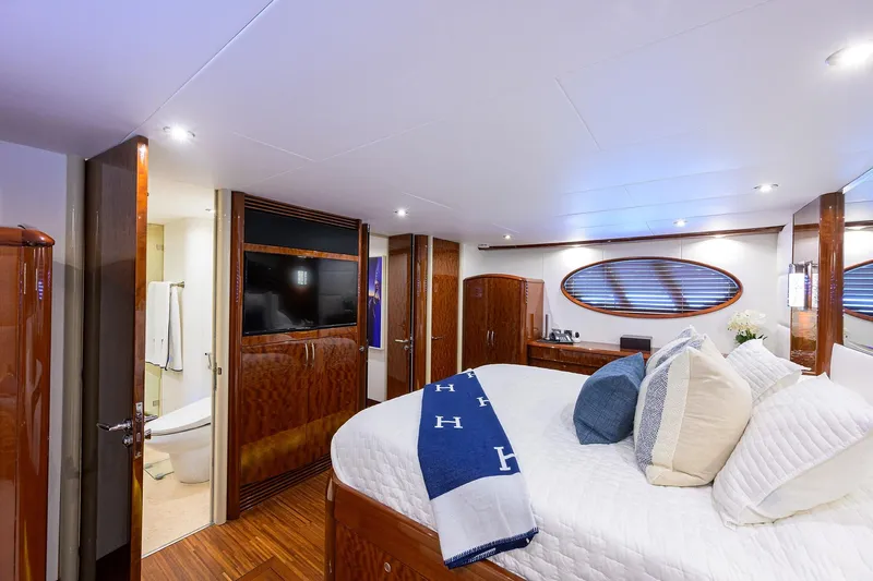Time Off V Yacht Photos Pics Luxurious bedroom interior of 2005 Lazzara 68 Enclosed Bridge yacht with elegant wood finishes.