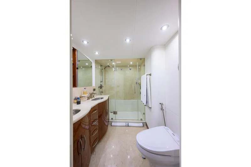 Time Off V Yacht Photos Pics Luxurious bathroom in 2005 Lazzara 68 Enclosed Bridge yacht with modern fixtures and glass shower.