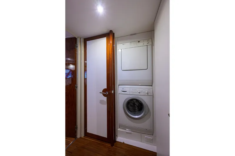 Time Off V Yacht Photos Pics Laundry area with stacked washer and dryer in 2005 Lazzara 68 Enclosed Bridge yacht.