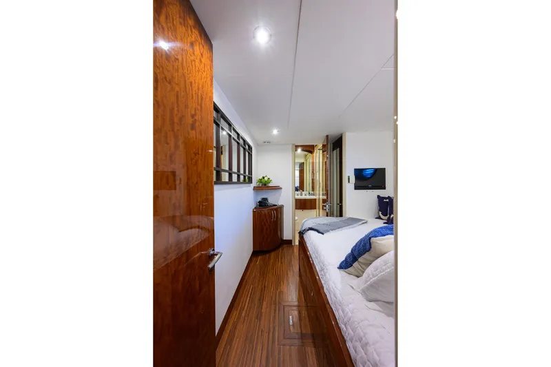 Time Off V Yacht Photos Pics Luxurious bedroom interior of 2005 Lazzara 68 Enclosed Bridge yacht with elegant wood finishes.