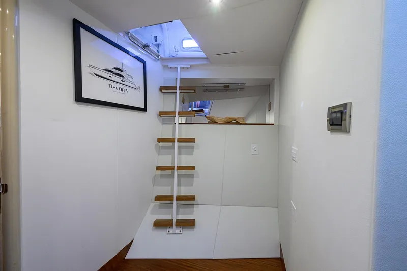Time Off V Yacht Photos Pics Interior of 2005 Lazzara 68 Enclosed Bridge yacht with ladder and framed artwork.