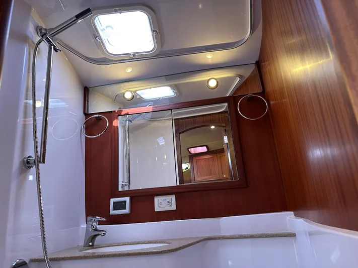 San Juan Yacht Photos Pics Luxurious bathroom in a 2015 San Juan 41 yacht with modern fixtures and wooden accents.