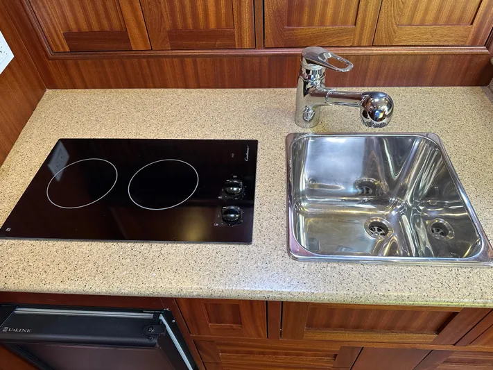 San Juan Yacht Photos Pics Modern galley kitchen in 2015 San Juan 41 boat with stovetop and stainless steel sink.