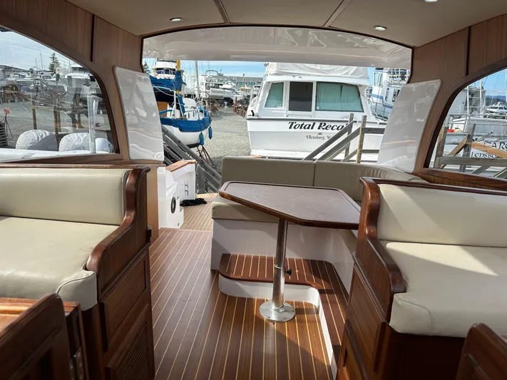 San Juan Yacht Photos Pics Interior of a 2015 San Juan 41 yacht with wood flooring and cushioned seating.
