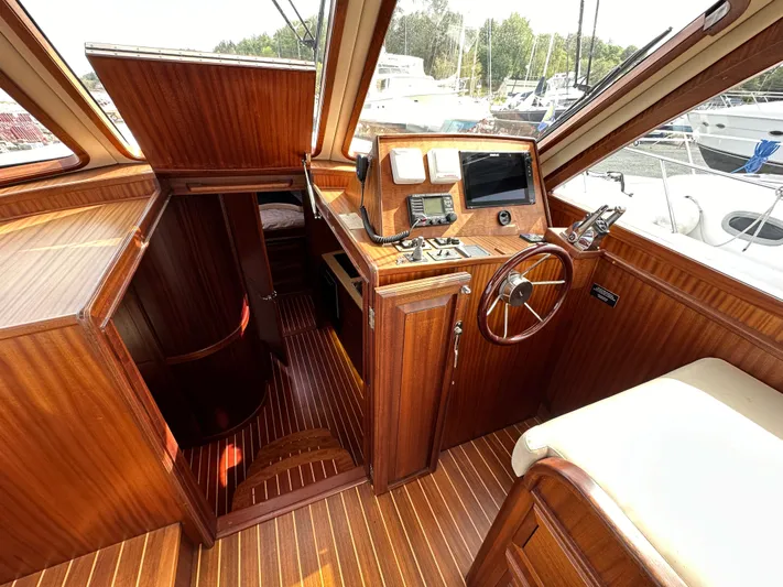 San Juan Yacht Photos Pics Interior of 2015 San Juan 41 boat with wooden helm and navigation equipment.