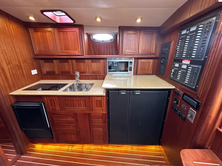 San Juan Yacht Photos Pics Luxurious 2015 San Juan 41 yacht kitchen with wood cabinetry, sink, stove, microwave, and control panels.