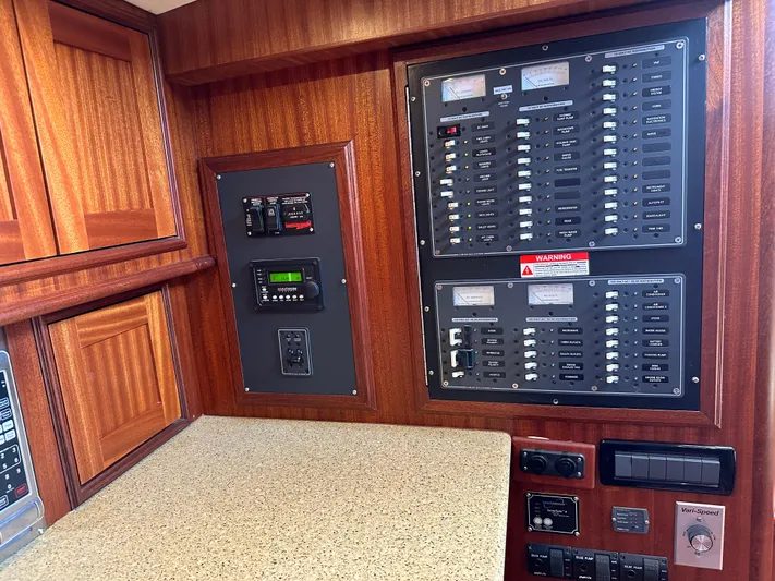 San Juan Yacht Photos Pics Electrical control panel on a 2015 San Juan 41 yacht with wooden cabinetry.