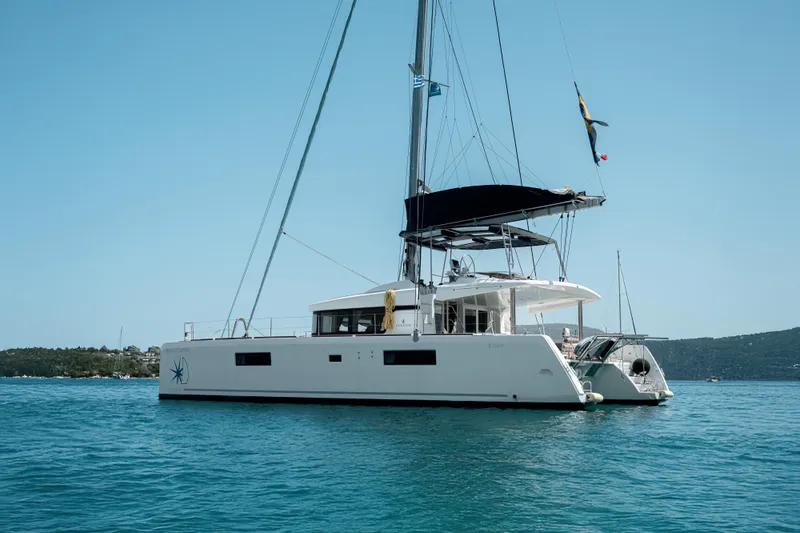  Yacht Photos Pics 2018 Lagoon 52 F catamaran sailing on calm blue waters.