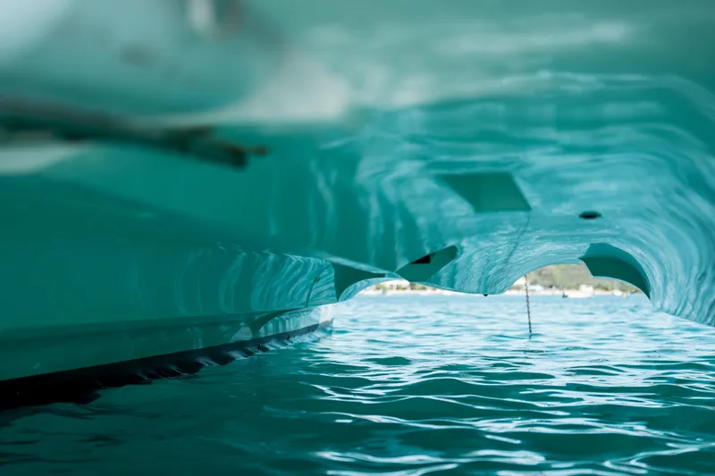  Yacht Photos Pics Underwater view of 2018 Lagoon 52 F catamaran hull in clear blue water.