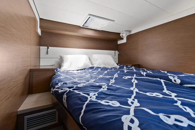  Yacht Photos Pics Luxurious cabin interior of 2018 Lagoon 52 F yacht with cozy bedding.