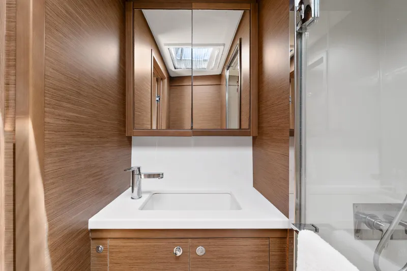  Yacht Photos Pics Modern bathroom interior on 2018 Lagoon 52 F yacht, featuring wood paneling and sleek fixtures.