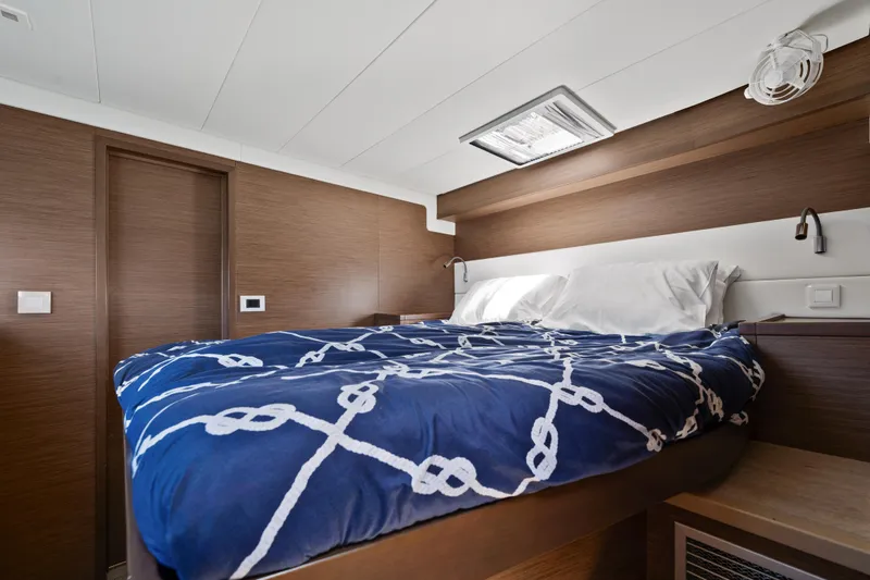  Yacht Photos Pics Luxurious cabin interior of 2018 Lagoon 52 F yacht with nautical bedding.