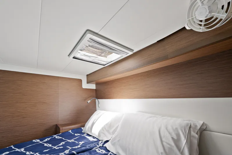  Yacht Photos Pics Luxurious cabin interior of 2018 Lagoon 52 F yacht with modern wood paneling.