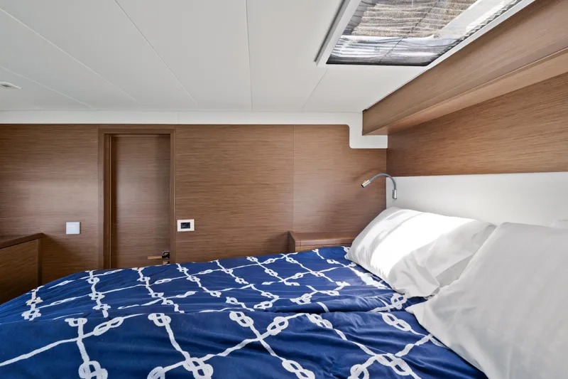  Yacht Photos Pics Luxurious cabin interior of 2018 Lagoon 52 F yacht with nautical bedding.