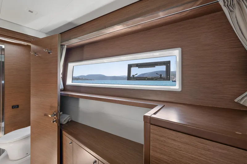  Yacht Photos Pics Interior of 2018 Lagoon 52 F yacht with wooden finish and sea view window.