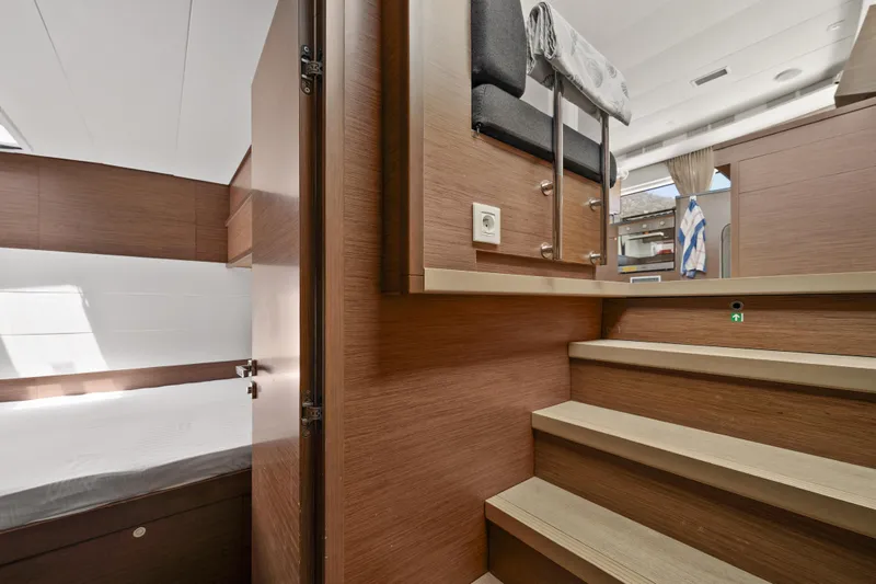  Yacht Photos Pics Interior of 2018 Lagoon 52 F yacht, featuring wooden stairs and modern design elements.