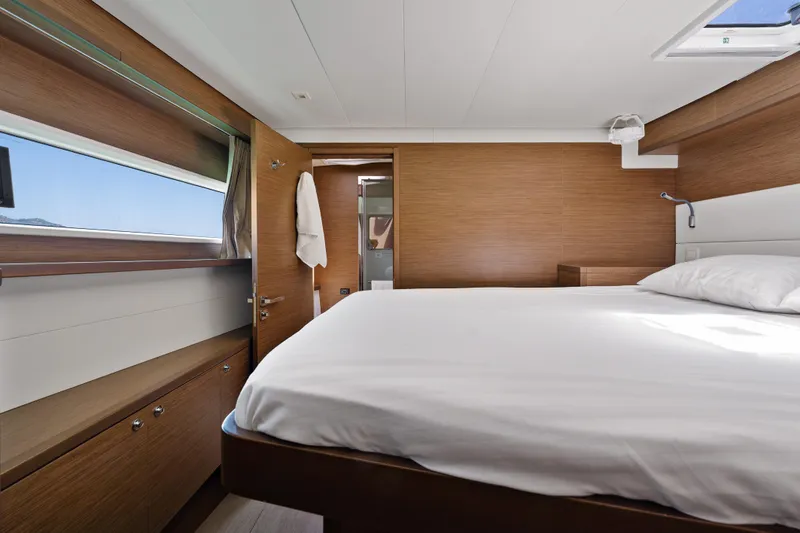  Yacht Photos Pics Luxurious cabin interior of 2018 Lagoon 52 F yacht with modern wood finish.