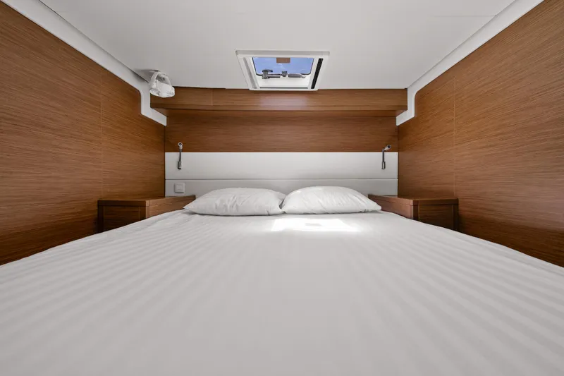  Yacht Photos Pics Luxurious cabin interior of 2018 Lagoon 52 F yacht with wood paneling and skylight.