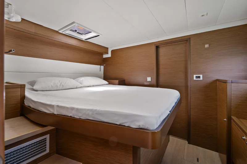  Yacht Photos Pics Luxurious cabin interior of 2018 Lagoon 52 F yacht with modern wood finish.