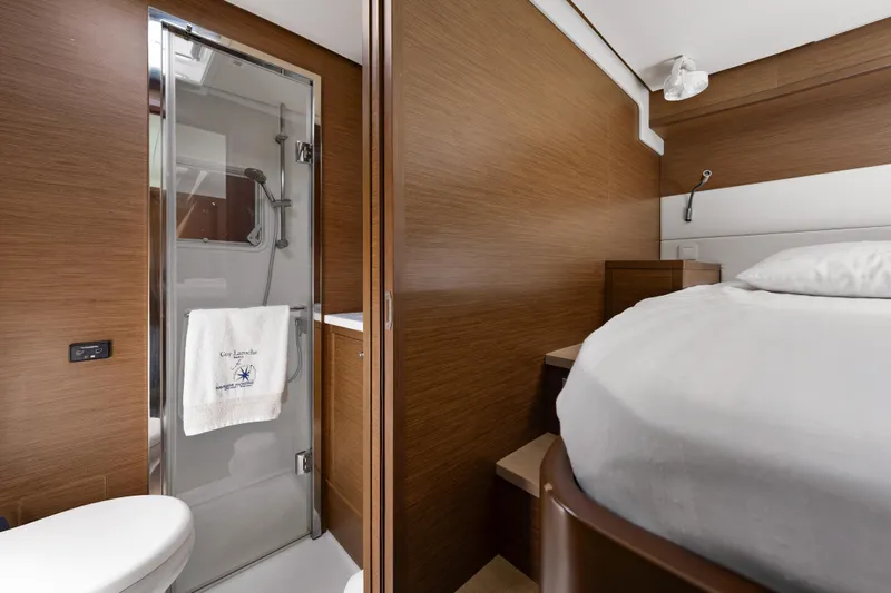  Yacht Photos Pics Luxurious interior of 2018 Lagoon 52 F yacht with modern bathroom and cozy bedroom.
