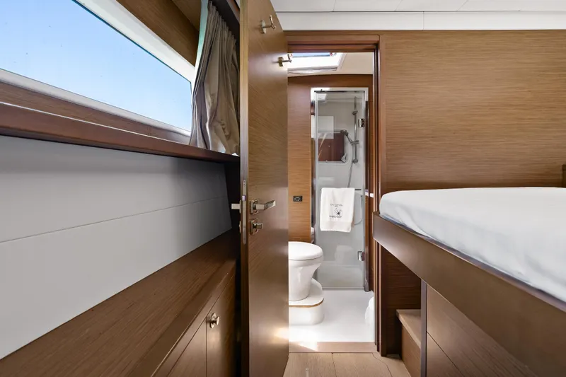  Yacht Photos Pics Luxurious interior of 2018 Lagoon 52 F yacht cabin with ensuite bathroom.