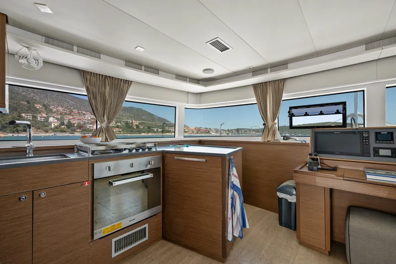  Yacht Photos Pics Interior of 2018 Lagoon 52 F yacht kitchen with modern appliances and scenic window views.