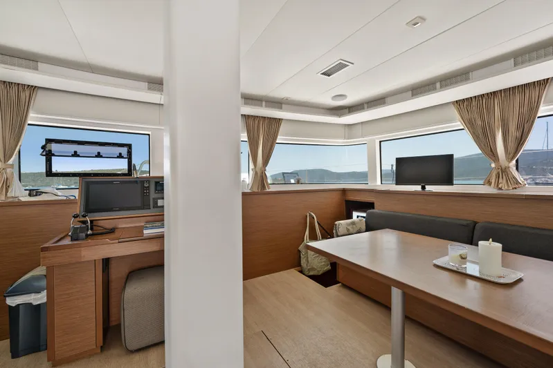  Yacht Photos Pics Interior of 2018 Lagoon 52 F yacht with navigation station and dining area.