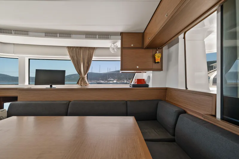  Yacht Photos Pics Interior of 2018 Lagoon 52 F yacht with modern seating and scenic window view.