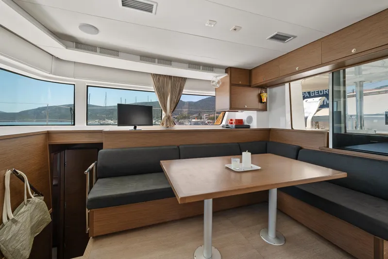  Yacht Photos Pics Interior of 2018 Lagoon 52 F yacht with modern dining area and scenic windows.