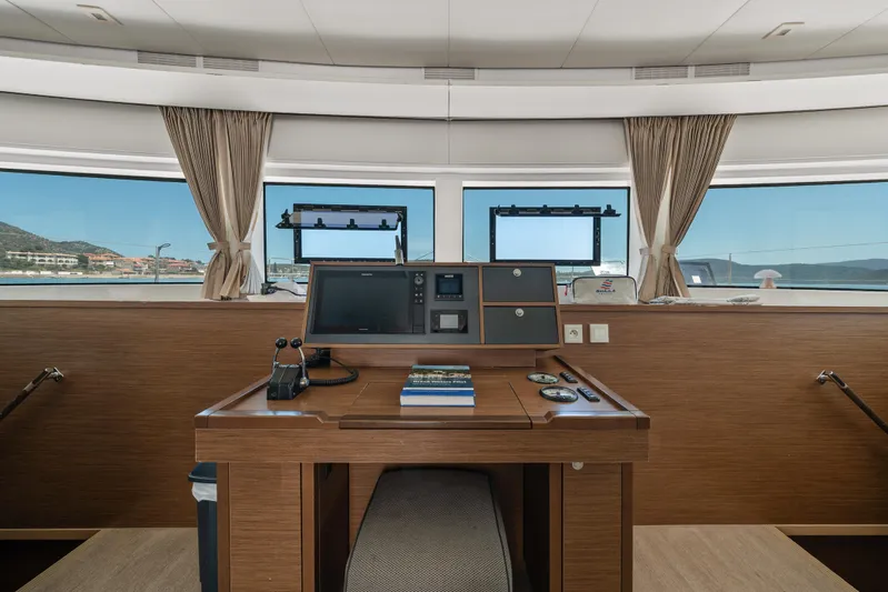  Yacht Photos Pics Interior helm station of 2018 Lagoon 52 F catamaran with navigation equipment and panoramic windows.