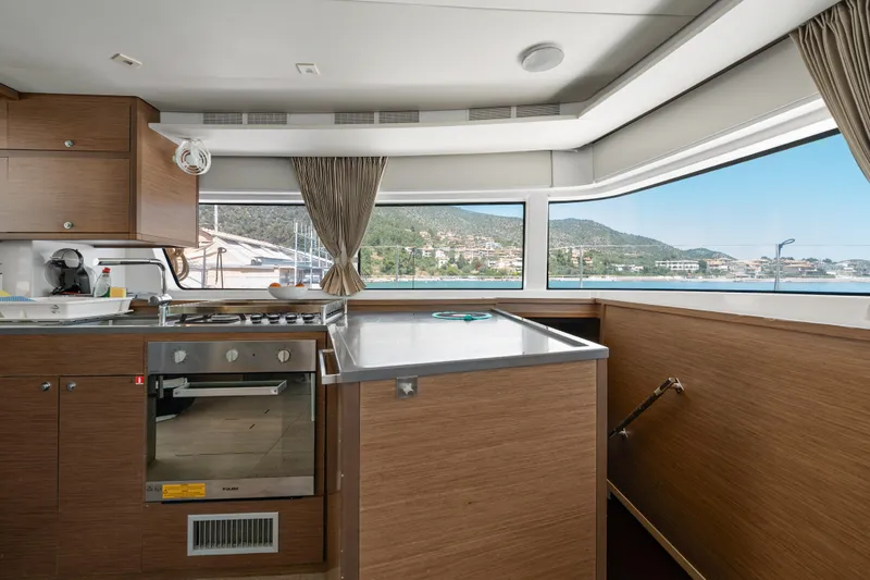  Yacht Photos Pics Interior of 2018 Lagoon 52 F yacht with modern kitchen and scenic window views.