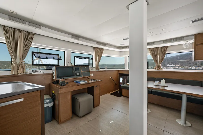  Yacht Photos Pics Interior of 2018 Lagoon 52 F yacht with modern navigation station and dining area.