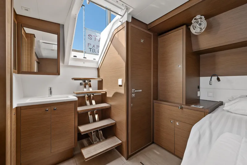  Yacht Photos Pics Luxurious interior of 2018 Lagoon 52 F yacht cabin with wooden finishes and modern amenities.