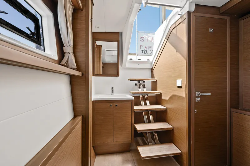  Yacht Photos Pics Interior of 2018 Lagoon 52 F yacht with wooden stairs and modern design.