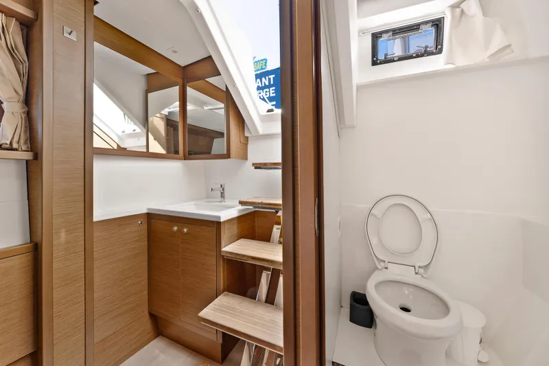  Yacht Photos Pics Luxurious 2018 Lagoon 52 F yacht bathroom with modern wood cabinetry and compact toilet.