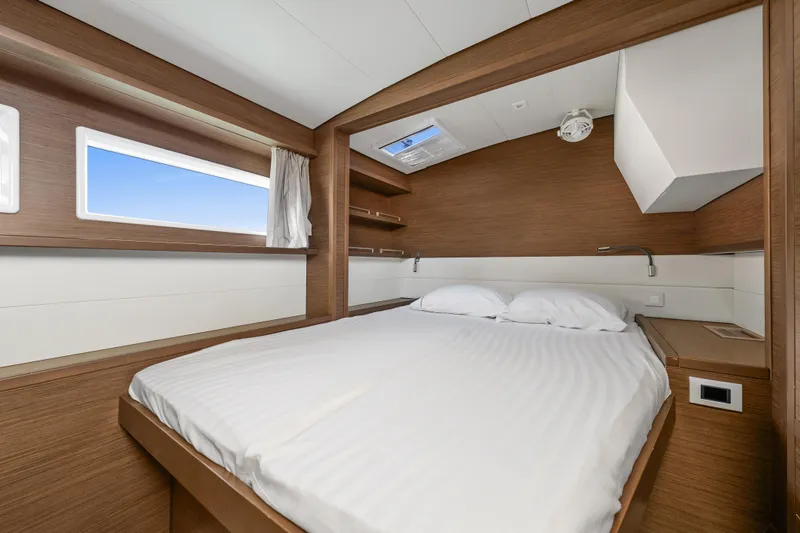  Yacht Photos Pics Luxurious cabin interior of 2018 Lagoon 52 F yacht with modern wood finish.