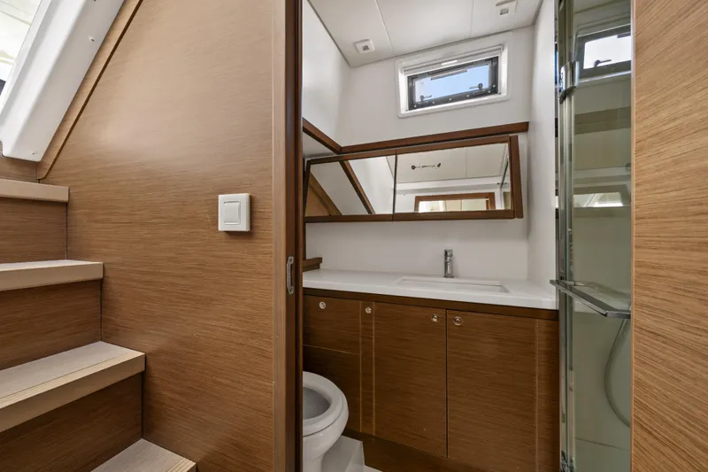  Yacht Photos Pics Luxurious bathroom interior on 2018 Lagoon 52 F yacht, featuring wood accents and modern fixtures.