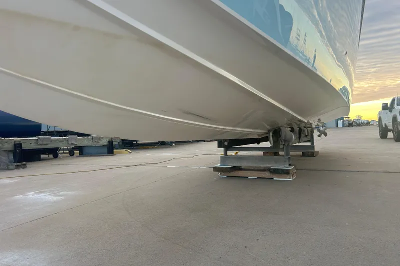  Yacht Photos Pics 2007 Fountain 38 Sportfish Cruiser OB on dry dock, side view at sunset.